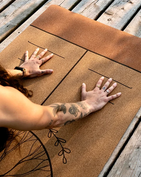 Hands on a Scoria printed cork yoga mat