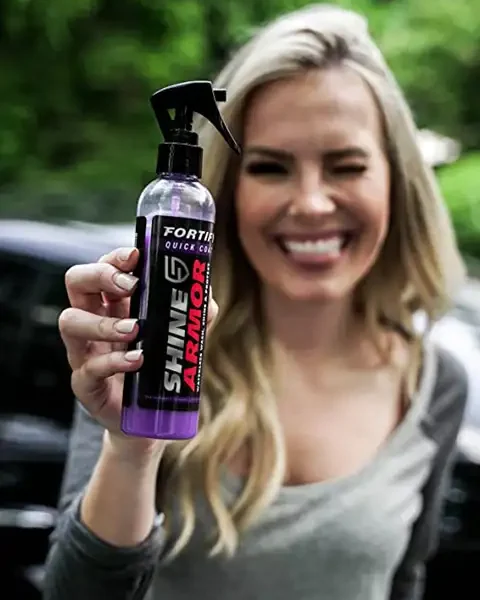Woman holding Shine Armor Fortify Quick Coat