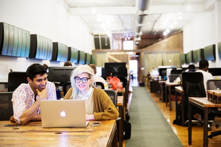 Man and woman with laptop in a Coworking space