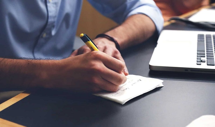 man writing content creation notes identifying his ideal client