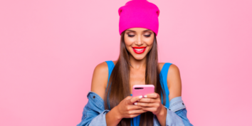 Instagram algorithm woman on phone pink background