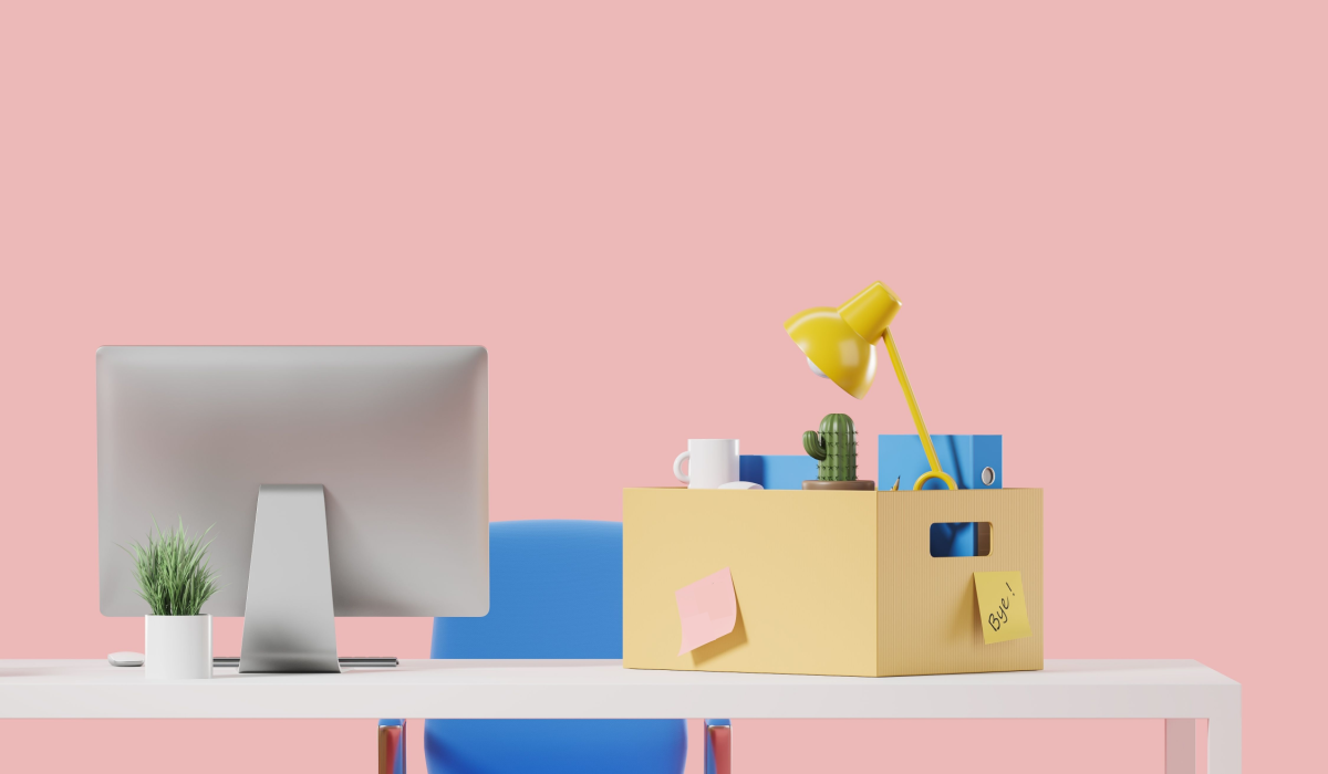 Desk with box filled someone quitting their job